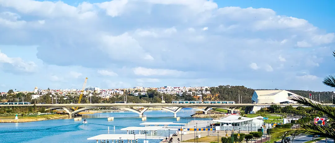 The Bouregreg between Rabat and Salé in daylight: the riverside promenade, the Hassan II bridge and the Grand Theatre in the distance