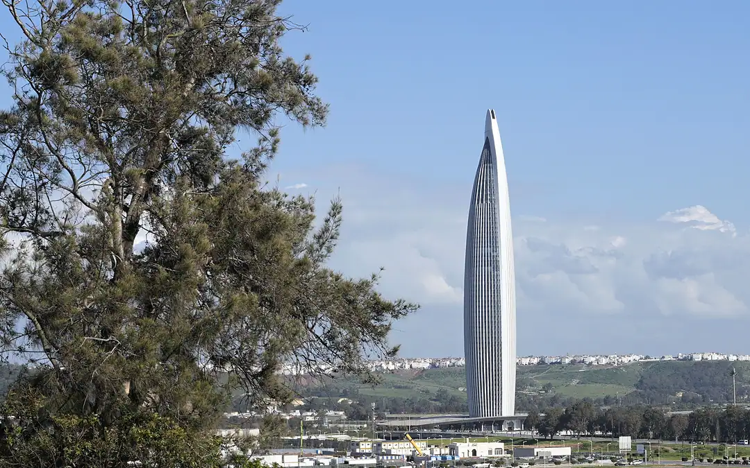 The Mohammed VI Tower rising above the Bouregreg valley between Rabat and Salé, spring daylight and a clear sky with scattered cloud