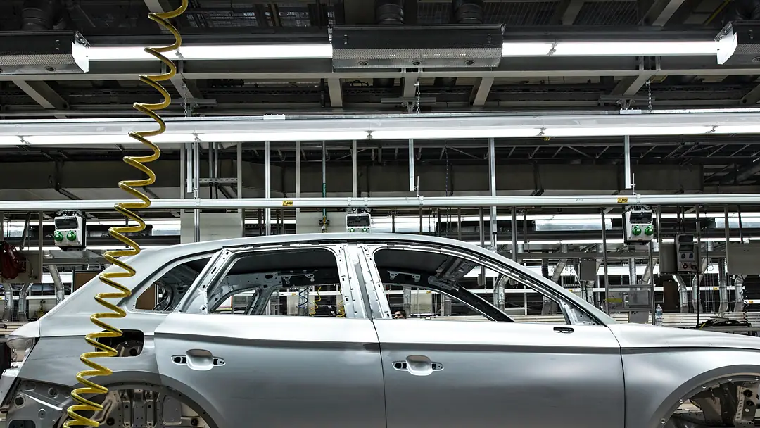 An unpainted car body on the assembly line of a car plant